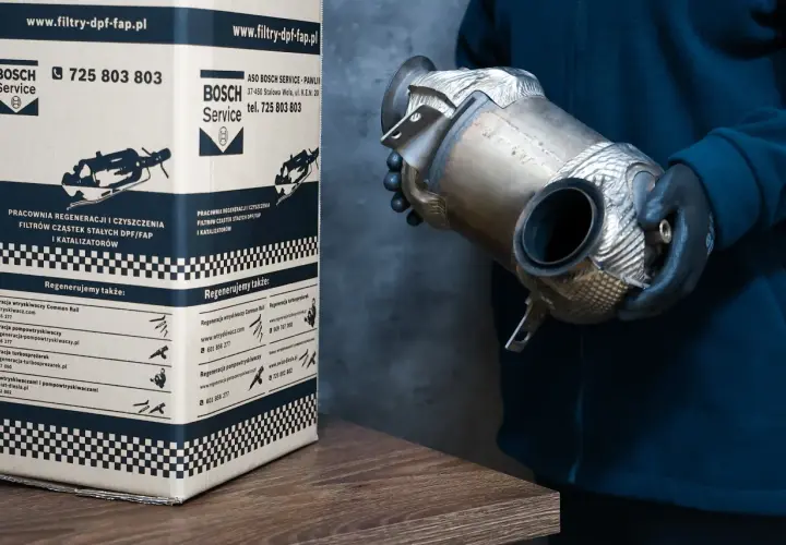 Osoba w rękawiczkach trzyma zregenerowany filtr DPF, kluczowy element w walce z zanieczyszczeniami spalin.